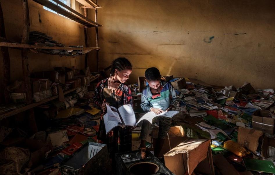Children look at books in an elementary school in the village of Bisober, Tigray on December 9, 2020. The school was occupied by Tigray Special Forces and also damaged after fighting broke out between Ethiopian and Tigray forces in November 2020.