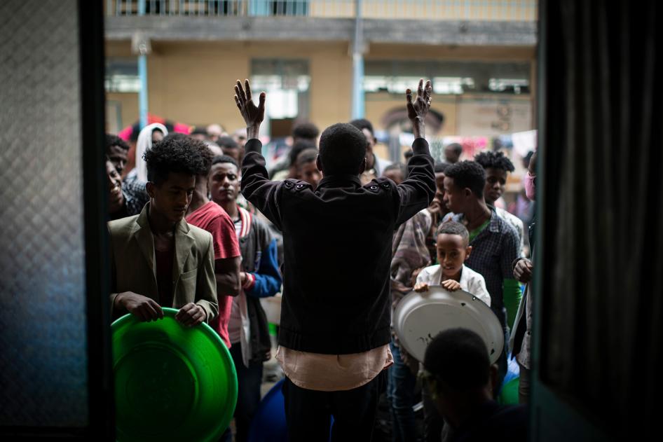 An organizer asks displaced Tigrayans to queue as they wait to receive food at a school in Mekele, in Ethiopia's northern Tigray region, May 5, 2021.