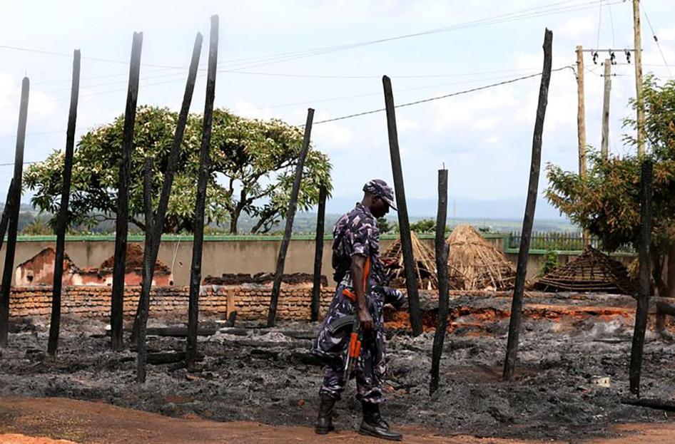 A Ugandan policeman guards the remains of the destroyed palace of Charles Wesley Mumbere, king of the Rwenzururu, after Uganda security forces stormed the compound in Kasese town, western Uganda on November 27, December 1, 2016.