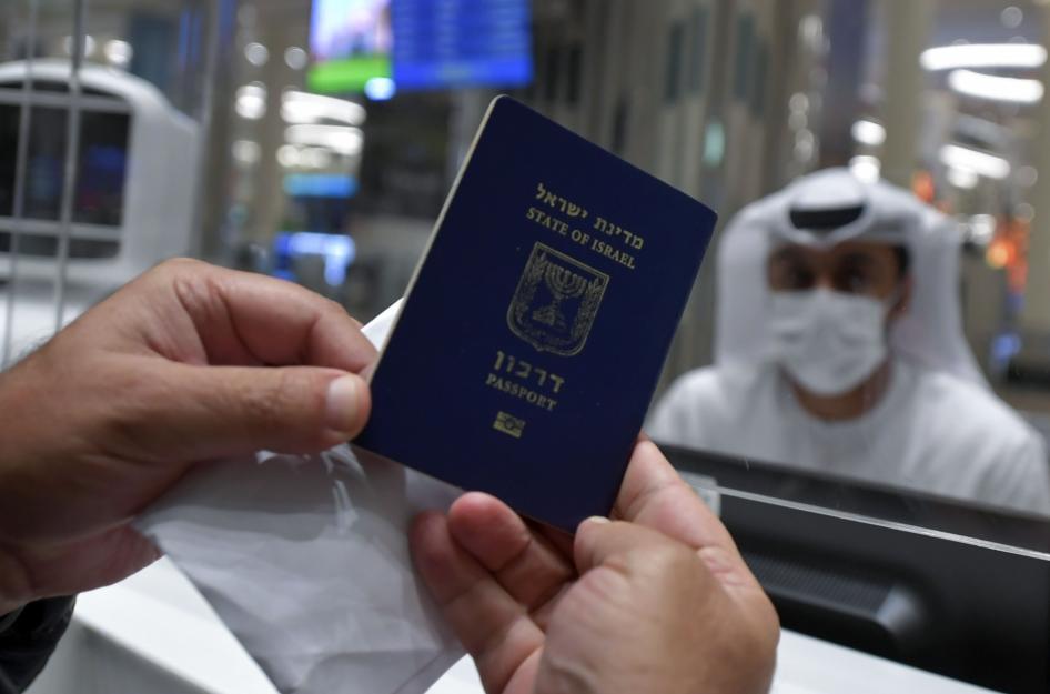 An Israeli man presents his passport for control upon arrival from Tel Aviv to the Dubai airport in the United Arab Emirates, on November 26, 2020.