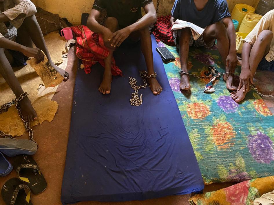 Four men sit chained in a room at the Coptic Church Mamboleo, in Kisumu city, western Kenya, where over 60 men, women, and children with real or perceived mental health conditions are detained. Staff at the church say residents are naked or partially clothed so that they do not run away or escape. 