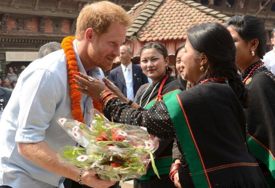 Nepalese girls welcome Britain's Prince Harry as he visits heritage sites in Patan Durbar Square in the outskirts of Kathmandu, March 20, 2016. 