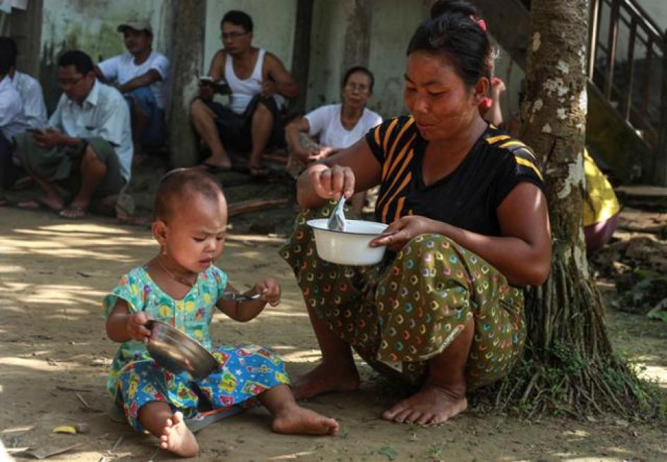 A woman who fled from recent violence in Maungdaw feeds her daughter at a monastery used as a temporary internally displaced persons (IDP) camp in Sittwe, Burma on October 15, 2016.