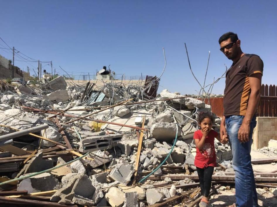 أشرف فواقة وابنته سيما (4 أعوام) يقفان قرب ركام بيتهما في القدس الشرقية يوم 15 مايو/أيار 2017، وقد هدمته السلطات الإسرائيلية لأنه بُني دون رخصة.