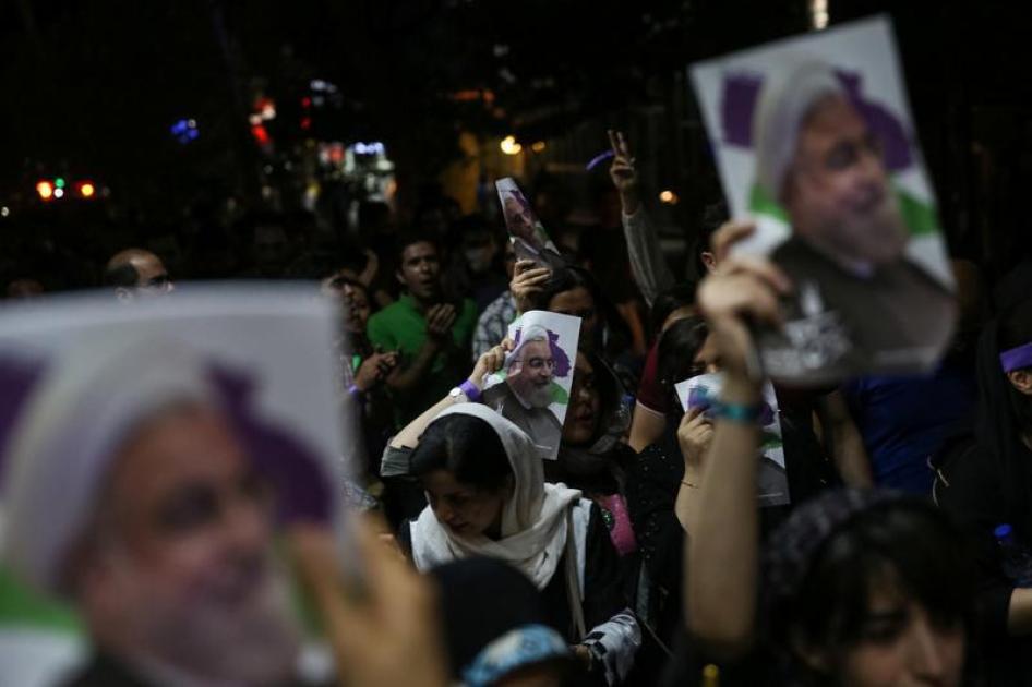 مساندون للرئيس الإيراني حسن روحاني يحملون صورا له أثناء احتفالهم بانتصاره في الانتخابات الرئاسية في شوارع طهران، إيران، 20 مايو/أيار 2017.