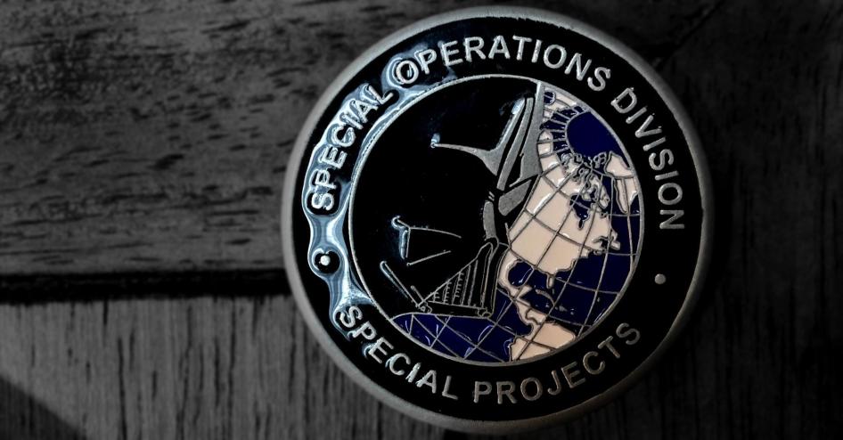 Medallion that includes the words ‘Special Operations Division’ with an image of Darth Vader over the globe on one side, and the words ‘Drug Enforcement Administration’ and the DEA logo on the other side. 
