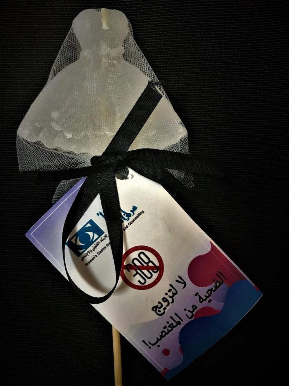 Photo showing a white dress symbolizing a bride produced by the Women’s Centre for Legal Aid and Counselling as part of their campaign to repeal article 308 which had allowed rapists to escape prosecution if they married their victims. The message in Arab