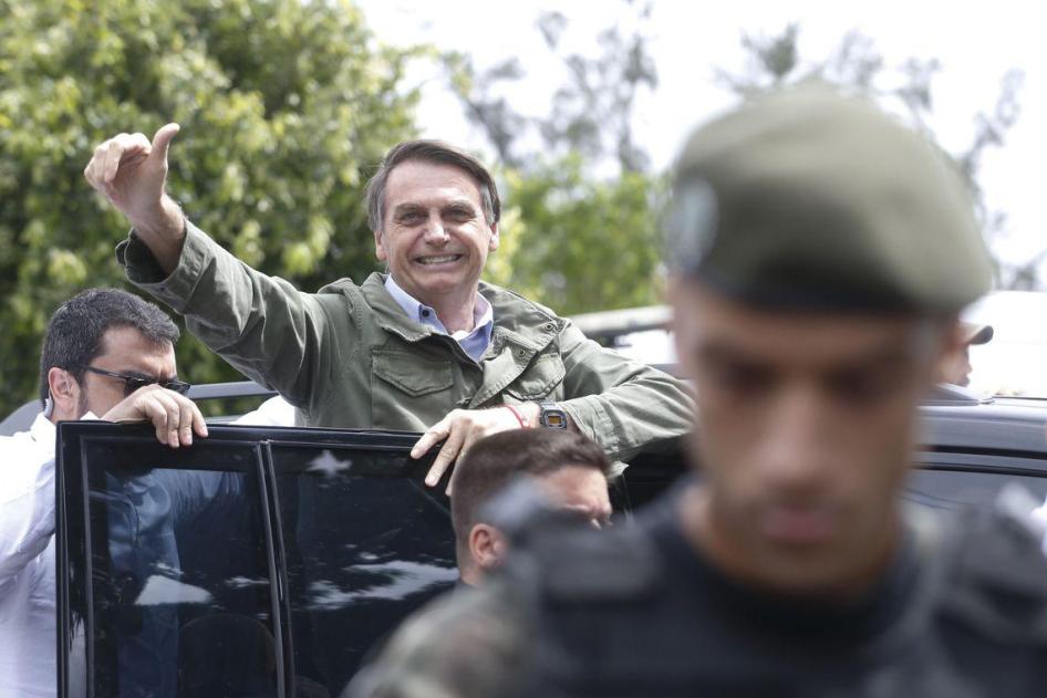Protected by Federal Police agents, Social Liberal Party (PSL) presidential candidate Jair Bolsonaro votes on October 28 at the Rosa da Fonseca Municipal School in Rio de Janeiro, Brazil.