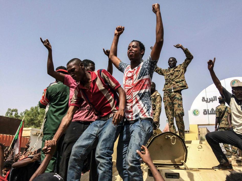 Peu après l’annonce de la destitution par l’armée du président soudanais, Omar el-Béchir, des manifestants ainsi que des soldats, debout sur un véhicule militaire, expriment leur joie à Khartoum, le 11 avril 2019.