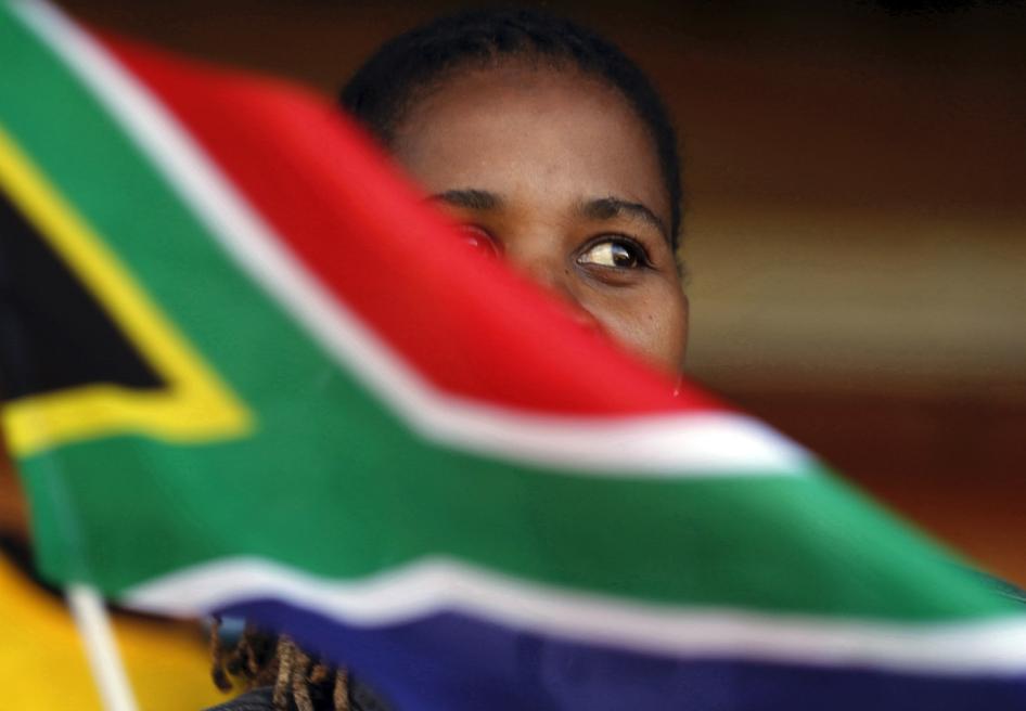A woman waves a South African flag as she attends Freedom Day celebrations in Kwa-Thema Township, near Johannesburg