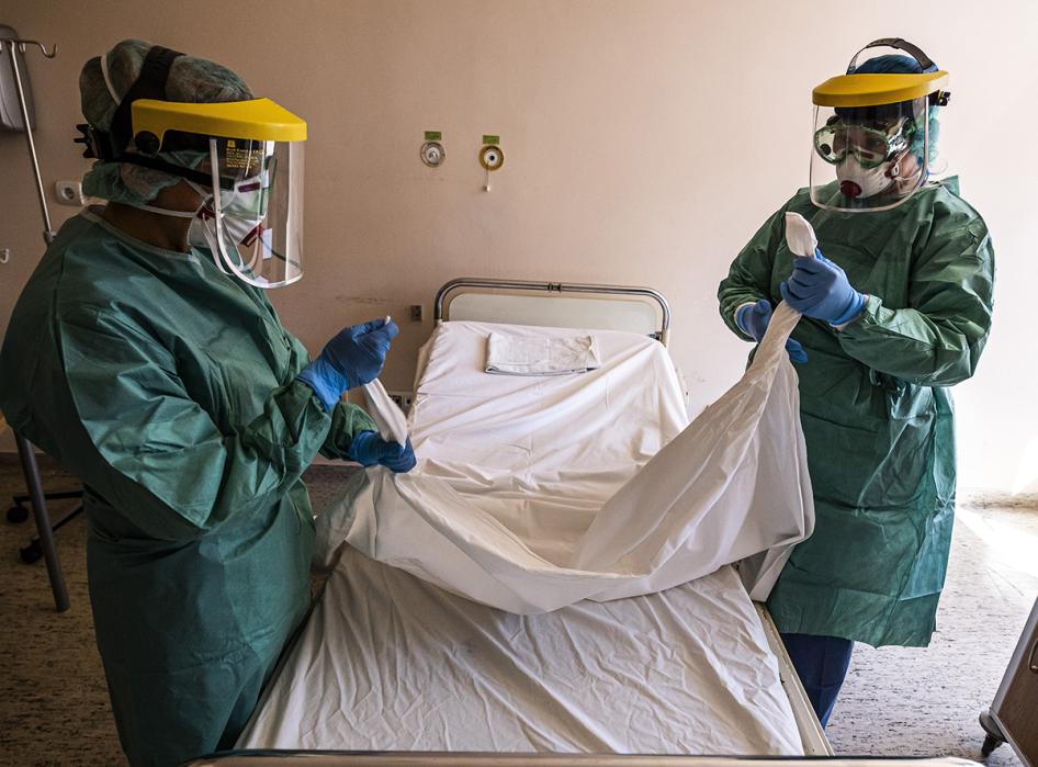 Nurses in protective gear prepare a ward designated for new patients infected with Covid-19 in a hospital in Budapest, Hungary, March 16, 2020.