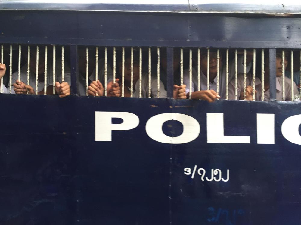 Police vans bring detained student protesters from the district courthouse to Tharrawaddy prison in Pegu region on October 27, 2015. 