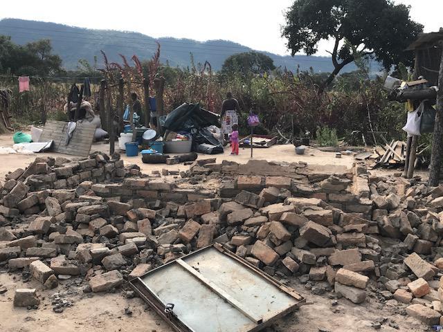 Two women in front of the remains of their demolished house at Arnolds Farm, Mazowe. Anti-riot police, who claim the farm is owned by the First Family, demolished the house on May 9, 2017, despite two court orders prohibiting the demolitions.