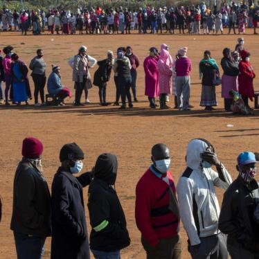 People affected by the coronavirus economic downturn, line up to receive food donations at the Iterileng informal settlement near Laudium, southwest of Pretoria, South Africa, Wednesday, May 20, 2020.
