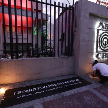 Employees light candles outside the headquarters of broadcast network ABS-CBN corp. on May 5, 2020, after the network was ordered to halt operations after its congressional franchise expired, in Quezon city, Metro Manila, Philippines.