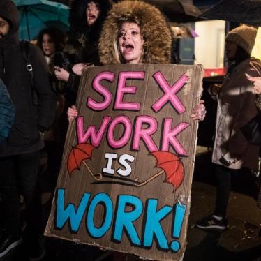 People take part in an International Women's Day march in London, England, against criminalization of sex work