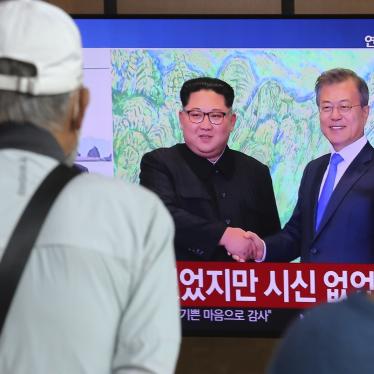 People watch a news program showing an image of North Korean leader Kim Jong Un, left, and South Korean President Moon Jae-in, right, at the Seoul Railway Station in Seoul, South Korea on Friday, Sept. 25, 2020. 