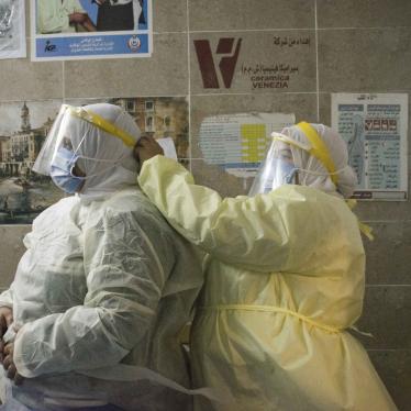 A nurse helps a colleague put on personal protective equipment at the 6th of October Central Hospital, an isolation hospital for Covid-19 patients, in Giza, Egypt, in July 2020.