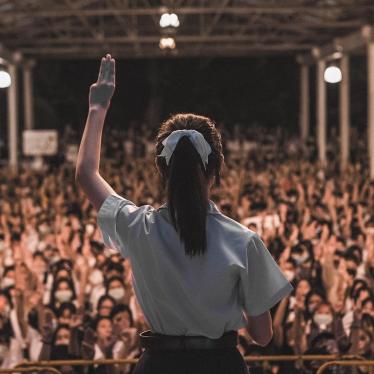 A high school student holds up the three-finger salute and gives a speech at a youth-led rally in Chiang Mai, Thailand on August 25, 2020. © 2020 Supitcha Chailom
