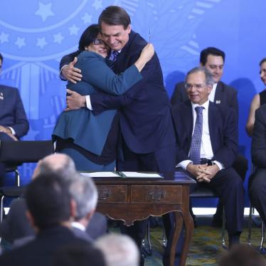 Brazilian President Jair Bolsonaro embraces the Minister of Women, Family, and Human Rights, Damares Alves, during a ceremony on August 29, 2019, in Brasilia, Brazil. ©Agência Brasil / Valter Campanato