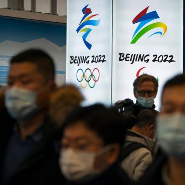 Attendees wearing face masks look at an exhibit at a visitors center at the Winter Olympic venues in Yanqing on the outskirts of Beijing, February 5, 2021.