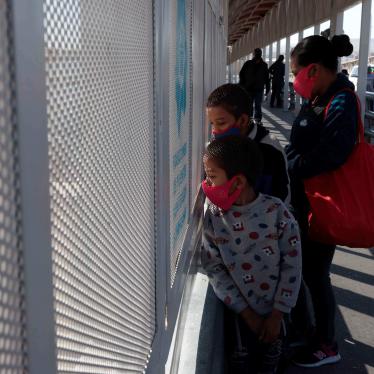 An asylum seeking family from Guatemala stands on the Paso del Norte international bridge. After border agents turned the family away at the port of entry, the family swam across the Rio Grande.
