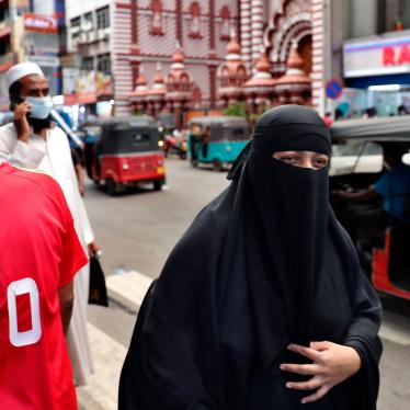 A Sri Lankan Muslim woman wearing a burka walks in a street in Colombo, Sri Lanka