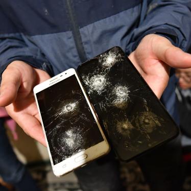 A man displays two broken phone screens