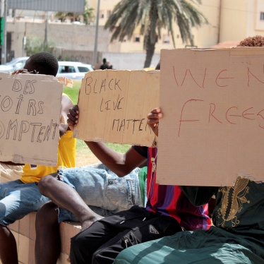 Migrants hold placards reading "Black Lives Matter", left in French, during a gathering in Sfax, Tunisia's eastern coast, on July 7, 2023.