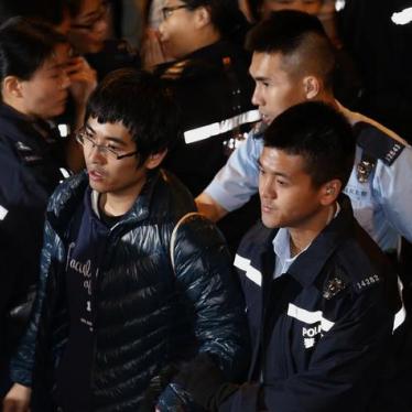Student leader Alex Chow is taken away by the police outside the government headquarters in Hong Kong on December 11, 2014. 