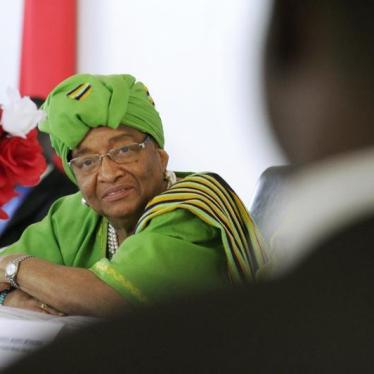 Liberia President Ellen Johnson Sirleaf (L) smiles during a meeting at City Hall in Monrovia, January 30, 2013.