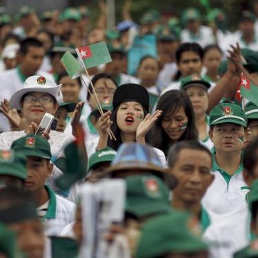 Supporters react during a a ruling Union Solidarity and Development Party (USDP) campaign rally in Rangoon, Burma on October 10, 2015.