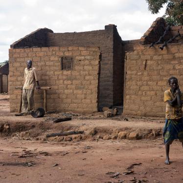 Residents of Marzé outside their burned home. Seleka and Peuhl fighters attacked the town in the Ouham province in July 2015. 