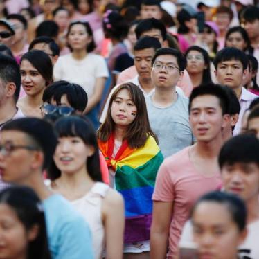 A woman wrapped in the rainbow flag is seen at the Pink Dot rally, Singapore's annual gay pride rally, at a park in Singapore July 1, 2017. 