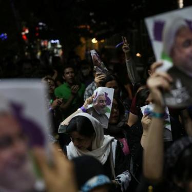 Supporters of Iran's President Hassan Rouhani carry pictures of him as they celebrate his victory in the presidential elections, in the streets of Tehran, Iran, May 20, 2017.
