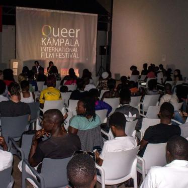 Audience members watch films screened during the sold-out opening night of the 2017 Queer Kampala International Film Festival. Police raided and forcibly closed the festival on December 9, 2017. 