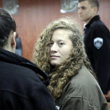 Palestinian teen Ahed Tamimi enters a military courtroom escorted by Israeli Prison Service personnel at Ofer Prison, near the West Bank city of Ramallah, January 1, 2018. © 2018 Reuters