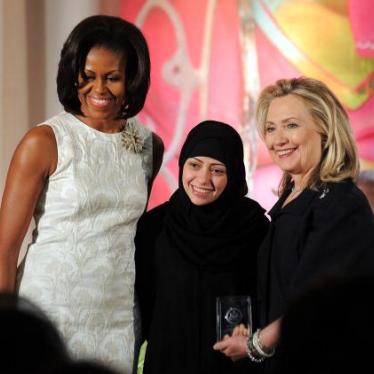 Former US First Lady Michelle Obama and former Secretary of State Hillary Clinton pose with Samar Badawi of Saudi Arabia as she receives the 2012 International Women of Courage Award during a ceremony at the US State Department in Washington, DC, on March