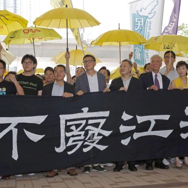Umbrella Movement leaders hold a banner before entering court in Hong Kong, April 24, 2019.