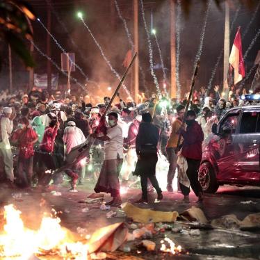 Fire crackers explode near supporters of presidential candidate Prabowo Subianto during clashes with the police in Jakarta, Indonesia, Wednesday, May 22, 2019.