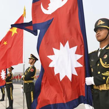 Chinese Honour Guard stand with Nepalese and Chinese flags ahead of a welcoming ceremony for the Nepalese President Bidhya Devi Bhandari