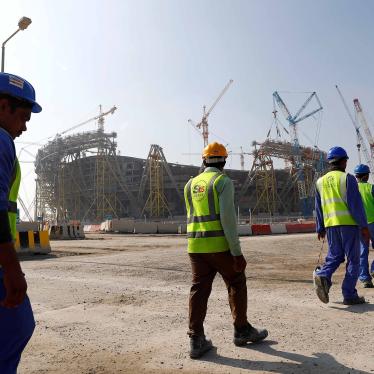 Workers walk towards the construction site of the Lusail stadium which will be build for the upcoming 2022 Fifa soccer World Cup during a stadium tour in Doha, Qatar, December 20, 2019. 