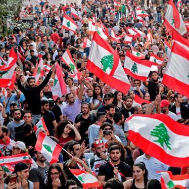 Lebanese protesters wave national flags during demonstrations to demand better living conditions on October 21, 2019 in downtown Beirut.